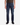 A man stands against a white background with arms relaxed at his sides, wearing PROJEK RAW’s ATLAS ATHLETIC FIT DENIM in a midnight blue wash and black shoes. His upper torso is partially visible, with the primary focus on the straight-leg jeans.