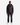 A man stands facing forward against a plain white background, wearing the PROJEK RAW MEN’S VEGAN LEATHER BOMBER JACKET in black, paired with dark jeans, a black shirt, and white sneakers.