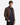 A young man with short brown hair stands against a plain white background, wearing the PROJEK RAW MEN’S VEGAN SUEDE MOTO JACKET with quilted shoulder detailing over a navy button-up shirt and black pants, with one hand in his pocket.