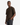 A man stands with one hand in his pocket, wearing the PROJEK RAW HONEYCOMB RELAXED FIT CREWNECK T-SHIRT in dark brown and dark jeans, looking at the camera against a plain white background.