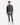 A person stands facing forward against a plain white background, wearing the PROJEK RAW RELAXED FIT HONEYCOMB CREWNECK SWEATER in dark gray, paired with light gray pants, a white undershirt, and white sneakers.