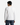 A person with short dark hair, wearing the PROJEK RAW RELAXED FIT HONEYCOMB CREWNECK SWEATER in white and blue jeans, stands facing away from the camera against a plain white background.