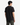 A person with short black hair, dressed in the PROJEK RAW CREWNECK SCUBA T-SHIRT and green pants, stands facing away from the camera against a plain white background.