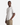 A man wearing the PROJEK RAW CREWNECK SCUBA T-SHIRT and beige pants stands with one hand in his pocket against a plain white background.