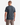 A man stands facing away, wearing the PROJEK RAW CLASSIC CREWNECK T-SHIRT in dark gray and light brown pants, set against a plain white background.