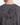 The back view of a person wearing the PROJEK RAW PRINTED COTTON SINGLE JERSEY T-SHIRT, featuring a gray fabric with a black abstract cracked pattern and a small rectangular label at the upper center.