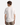 A young man with short brown hair is standing with his back to the camera, wearing the PROJEK RAW COTTON BLEND LONG SLUB T-SHIRT and light brown pants, against a plain white background.