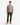 A person stands facing forward against a plain white background, wearing the PROJEK RAW RELAXED FIT KNIT CORD CREWNECK SWEATER in beige, paired with dark green pants and tan lace-up shoes.