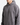 A person wearing a RELAXED FIT TERRY FLEECE HOODIE by PROJEK RAW in plain gray, featuring a front pocket, stands against a white background. The image shows only the upper body and part of the face, emphasizing this cozy layer designed for everyday comfort.