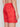 A person is shown from the waist down, side and back view, wearing Projek Raw BRYSON-CORAL swim trunks featuring a geometric red pattern, elastic waistband, and a back flap pocket.