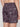A person is shown from the waist down wearing Projek Raw PATRICK-CHARCOAL swim trunks, featuring a dark plaid pattern with palm trees and pink accents, against a plain light-colored background.