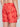 A person is shown from the back wearing Projek Raws BRUNO-PAPAYA swim trunks, featuring a palm tree pattern in red, an elastic waistband, and a zippered back pocket.