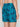 A person shown from behind, waist down, wearing Projek Raw BRUNO-TURQUOISE swim trunks featuring a navy palm tree pattern, elastic waistband, and side pocket.