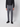 Wearing PROJEK RAW Mens 5-pocket Classic Stretch Bungee Pants in gray with a dark long-sleeve shirt and black shoes, a model stands against a plain white background. The photo, cropped at the shoulders, shows only the lower half.