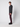 A young man with curly hair stands sideways, looking at the camera. He wears a PROJEK RAW Mens Long Sleeve Hoodie with Kangaroo Pocket, burgundy slim-fit pants, and black sneakers against a plain light gray background.