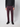 A person wearing maroon PROJEK RAW Mens 5-pocket Classic Stretch Bungee Pants, a black long-sleeve shirt, and black sneakers stands against a plain light gray background with only the lower half of the body visible.