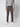 A person in a light gray button-up shirt, PROJEK RAW Mens Bungee Relaxed Chino Pant, and white sneakers stands against a plain light background. The image is cropped at the shoulders.