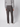 A person is shown from the back, standing against a plain light background, wearing a light gray long-sleeve shirt, PROJEK RAW Mens Bungee Relaxed Chino Pant in dark gray, and white sneakers.