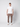 A young man stands against a plain light background, wearing the PROJEK RAW Men’s Stretch Bungee Cargo Jogger in taupe, a white t-shirt, and white sneakers. His arms are at his sides, facing forward with a neutral expression.