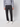 A person models the PROJEK RAW Men’s 5-Pocket Pant in light gray with a matching sweatshirt and white sneakers, standing against a plain background. Their arms are relaxed and their head is not visible in the image.