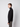 A man with short light brown hair is standing sideways, facing left, wearing the PROJEK RAW Mens Long Sleeve Turtleneck Sweater and gray pants against a plain light background.