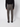 A person wearing PROJEK RAW Men’s Relaxed Chino Pant, a black sweater, and black shoes stands with their back to the camera against a plain white background.