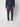 A person wearing PROJEK RAW Men’s Textured Bungee Pull-on Chino Pant in dark navy, a matching long-sleeve top, and white sneakers stands against a light background with their face not visible.