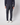 A person stands facing away, wearing PROJEK RAW Men’s Textured Bungee Pull-on Chino Pant and a matching long-sleeve top with white sneakers against a plain light background.