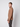 A young man stands sideways, looking at the camera, wearing the PROJEK RAW Mens Half-zip Cashmere Touch Sweater in light brown with dark trousers against a plain light gray background.