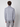A man faces away from the camera, wearing a light gray PROJEK RAW Mens Long Sleeve Turtleneck Sweater and gray plaid pants against a plain light background.