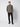 A young man faces forward, hand in pocket, wearing the PROJEK RAW Mens Casual Dress Shirt with Logo Detail—green with chest pockets—paired with black pants and shoes. He stands against a plain background, expression neutral.