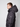 A young man with short brown hair stands in profile against a plain light background, wearing a PROJEK RAW Mens Quilted Ecofill Puffer with hood featuring a small white arrow logo on the sleeve.