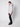 A young man stands sideways against a plain background, wearing the PROJEK RAW Mens Quilted Ecofill Puffer with hood, paired with black pants and boots—an ideal cold weather look.