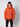 A young person stands against a plain background, wearing a PROJEK RAW Mens Quilted Ecofill Puffer with hood in orange, paired with a black beanie and black pants. Their hands rest relaxed at their sides.