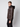 A young man with short light brown hair models the PROJEK RAW Mens Vegan Leather Moto Jacket with Removable Hood, standing sideways and looking at the camera against a plain light gray background.