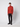 A young man stands against a plain light background, wearing a long-sleeve rust quarter-zip sweater, PROJEK RAW Mens Relaxed 5-Pocket Pant, and black shoes.