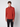 A young man with curly brown hair models PROJEK RAW Mens Relaxed 5-Pocket Pant and a rust-red long-sleeve quarter-zip sweater, standing against a plain light gray background and looking straight at the camera.