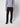 A person stands against a plain white background, wearing PROJEK RAW Mens 5-pocket Classic Stretch Bungee Pants, a light gray long-sleeve sweater, and black shoes. The image is cropped at the neck to show only the body and legs.