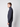A man stands in profile against a plain light background, wearing a PROJEK RAW Mens Half-zip Cashmere Touch Sweater in dark gray and dark pants, looking straight ahead with a neutral expression.