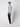 A young man in a PROJEK RAW Mens Long Sleeve Full Zip Mock Neck Sweater (light gray), black pants, and white sneakers stands against a plain background, facing slightly to the side with a neutral expression.