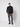 A young man with short hair stands against a plain light gray background, wearing a PROJEK RAW Mens Zip Mock Neck Sweater, gray cargo pants, and black sneakers. He has a relaxed expression and keeps his hands at his sides.