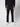A man in PROJEK RAW Mens 5-Pocket Flex Knit Jeans, a black long-sleeve shirt, and white sneakers stands against a plain light background. The photo is cropped just below his shoulders.