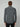 A person with light brown hair is shown from behind, wearing the PROJEK RAW MENS 24/7 BUTTON-UP KNIT SHIRT in charcoal gray with black pants, set against a plain light gray background.