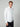 A man with short, light brown hair wears the PROJEK RAW MENS 24/7 BUTTON-UP KNIT SHIRT and dark pants, standing against a plain light gray background with one hand in his pocket.