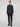 A person with light skin and short brown hair faces forward, wearing the PROJEK RAW MENS LONG SLEEVE 4WAY STRETCH TWILL SHIRT, paired with black pants and black shoes against a plain light background.