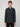 A young man with short light brown hair wears a black PROJEK RAW MENS LONG SLEEVE 4WAY STRETCH TWILL SHIRT, standing facing the camera against a plain light gray background.